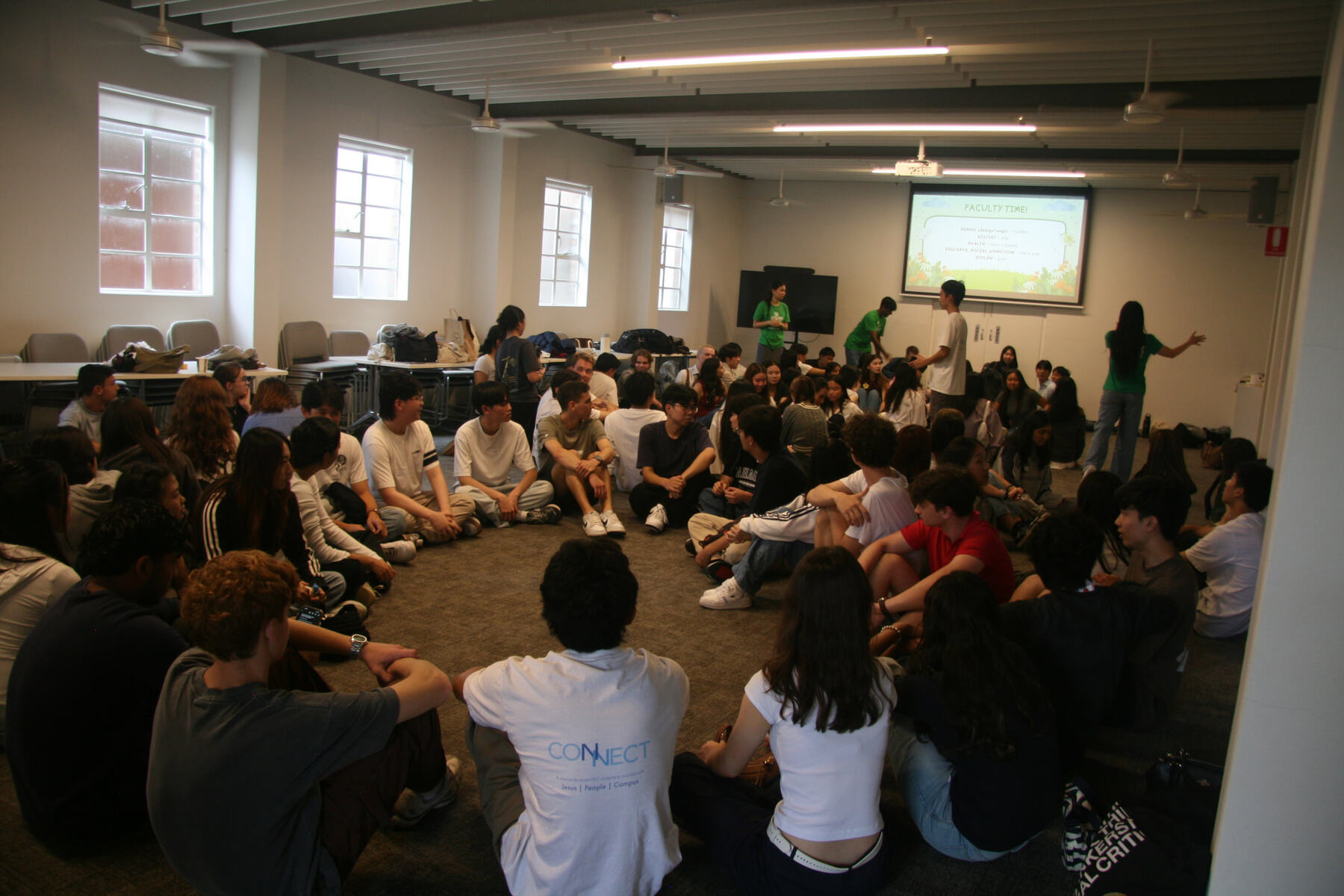 Grads sitting together in a circle at Campus Time